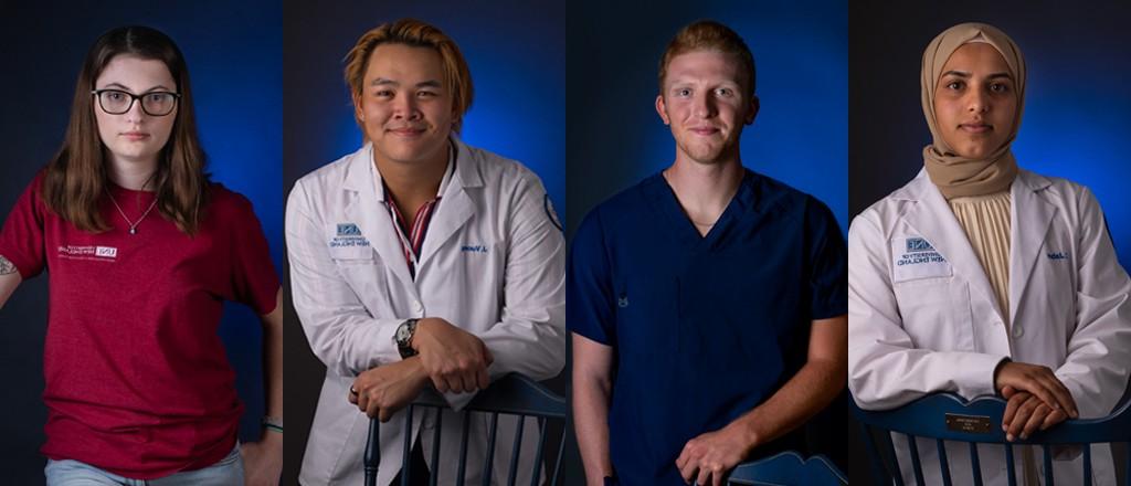 Portraits of two graduate and two undergraduate U N E students standing in front of a blue wall